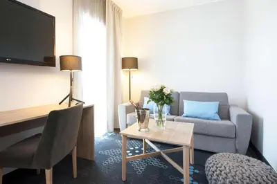 a living room with a couch and a table at Thon Hotel Elgstua in Elverum