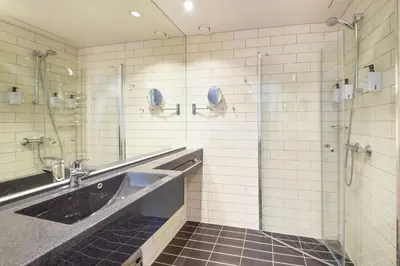 a bathroom with a shower and a sink at Thon Hotel Elgstua in Elverum