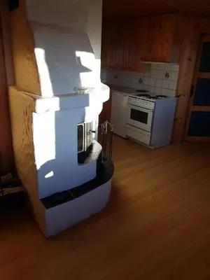 a kitchen with a stove and a counter top at Fjellbu Two-bedroom Cottage in Geilo