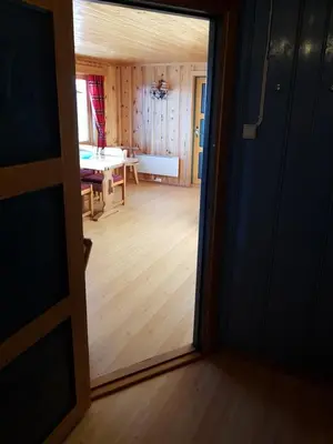 an open door to a room with a dining room at Fjellbu Two-bedroom Cottage in Geilo