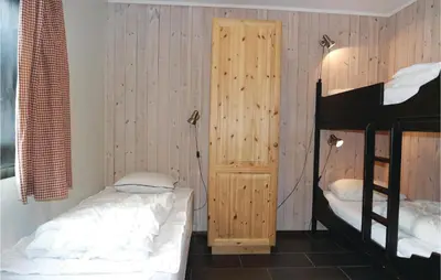 a bedroom with two beds and a bunk bed at 2 Bedroom Awesome Apartment In Hemsedal in Hemsedal