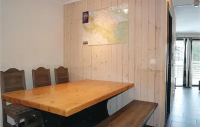 a room with a wooden table and a map on the wall at 2 Bedroom Awesome Apartment In Hemsedal in Hemsedal
