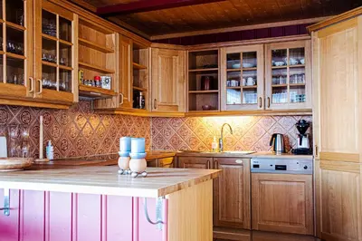 a kitchen with wooden cabinets and a counter top at Høvringen Fjellstue in Høvringen