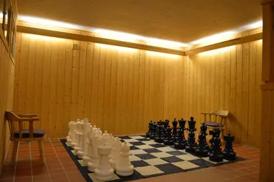 a room with a chess board and chess pieces on a checkerboard at Høvringen Fjellstue in Høvringen