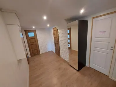 a hallway with two doors and a mirror at Bazyl Apartment in Folkedal