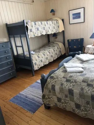 a bedroom with two beds and a bunk bed at Bygdin Høyfjellshotell in Beitostøl