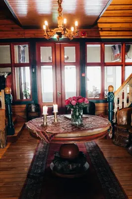 a living room with a table with flowers and candles at Tuddal Høyfjellshotel in Tuddal
