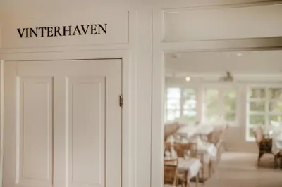 a white door with a sign that reads winterhaven at Jegtvolden Fjordhotell in Straumen