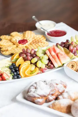 a table topped with three plates of food with different foods at Jegtvolden Fjordhotell in Straumen