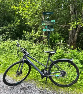 a bike is parked next to a street sign at Orkla Camping in Orkanger