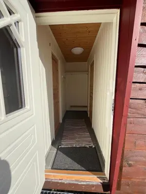 a hallway leading into a house with a door at Bua in Viksdalen