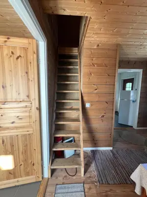 a staircase in a log cabin with a room at Bua in Viksdalen