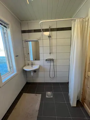 a bathroom with a shower and a sink at Bua in Viksdalen