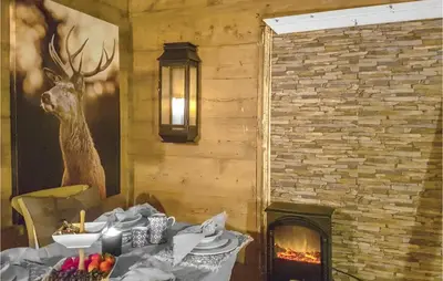 a dining room with a table and a fireplace at 3 Bedroom Lovely Home In Vikanes in Eiknes