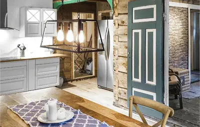 a kitchen with white cabinets and a green door at 3 Bedroom Lovely Home In Vikanes in Eiknes
