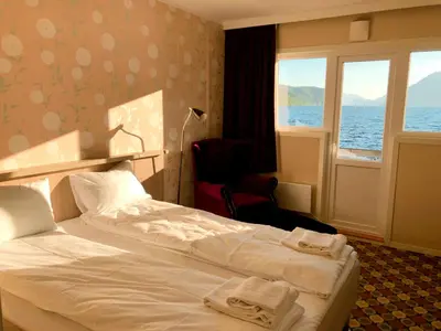 a hotel room with a bed and a window at Havila Hotel Raftevold in Hornindal