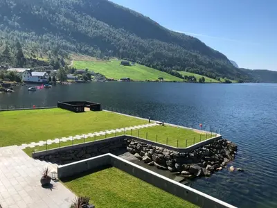 a large body of water with a dock in the middle at Havila Hotel Raftevold in Hornindal