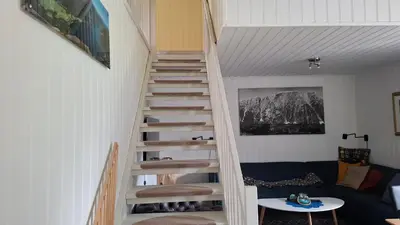 a spiral staircase in a living room with a couch at Ålfotevegen 5 in Ålfoten
