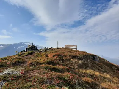 a bench sitting on top of a hill at Ålfotevegen 5 in Ålfoten