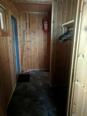 a room with a wood paneled wall and a fire hydrant at Granbu in Geilo