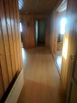 an empty room with wooden walls and a wooden floor at Granbu in Geilo