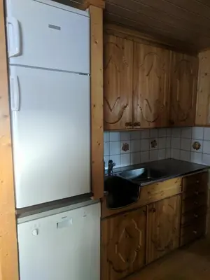 a kitchen with a white refrigerator and a sink at Granbu in Geilo