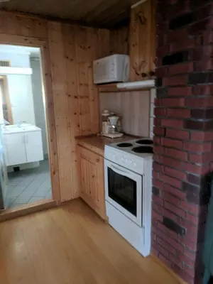 a kitchen with a white stove and a brick wall at Granbu in Geilo