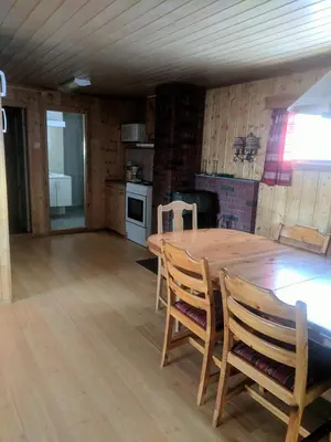 a kitchen with a wooden table and chairs in a room at Granbu in Geilo