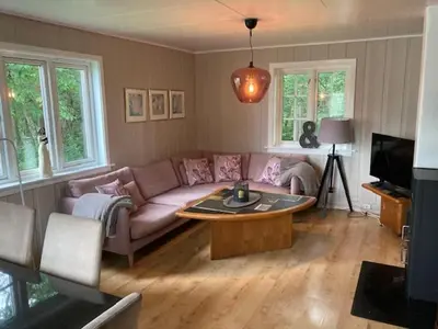 a living room with a couch and a coffee table at Voss Interlake in Skulestadmo