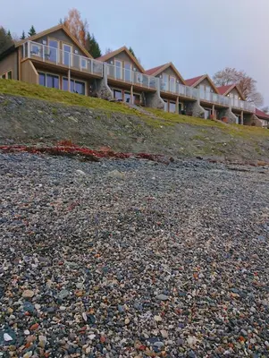 a large building on top of a rocky hill at Hjellup Fjordbo in Leksvik