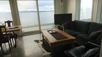 a living room with a couch and a coffee table at Hjellup Fjordbo in Leksvik