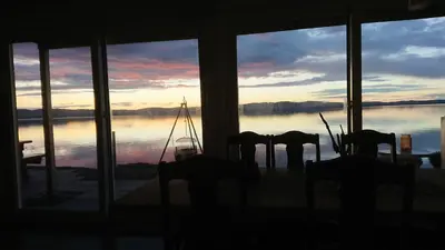 a view of a lake from a room with windows at Hjellup Fjordbo in Leksvik