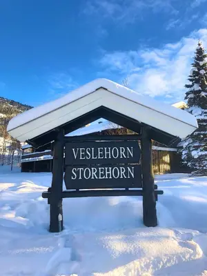 a sign in the snow in front of a building at Storehorn Apartments in Hemsedal
