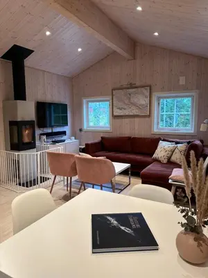 a living room with a couch and a table at Fresh Familie Hytte Hemsedal with Outdoor Sauna in Hemsedal