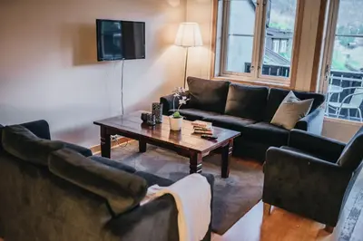 a living room with couches and a coffee table at Hovdehytta in Hovden
