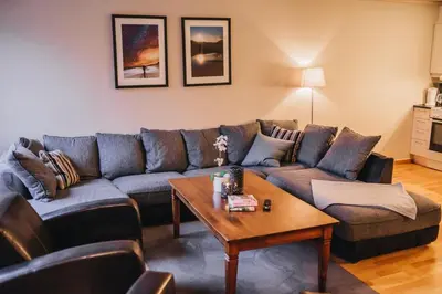 a living room with a couch and a table at Hovdehytta in Hovden