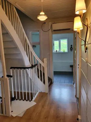 a hallway of a house with a staircase and a window at Solheim Gard in Stryn
