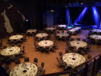 a room filled with tables and chairs with white table settings at Grand Hotel - by Classic Norway Hotels in Åndalsnes