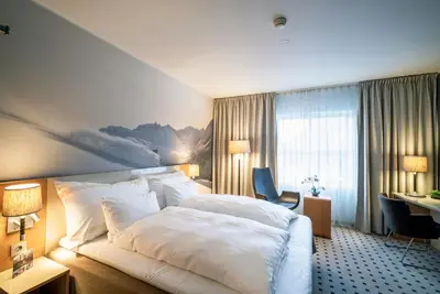 a hotel room with a bed and a desk at Grand Hotel - by Classic Norway Hotels in Åndalsnes