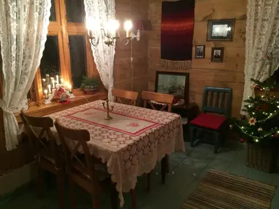 a dining room with a table and a christmas tree at Skjerping gård in Lonevåg