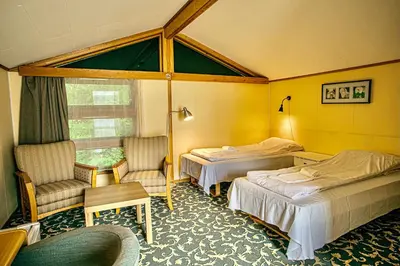 a hotel room with two beds and a window at Sauda Fjordhotell in Saudasjøen