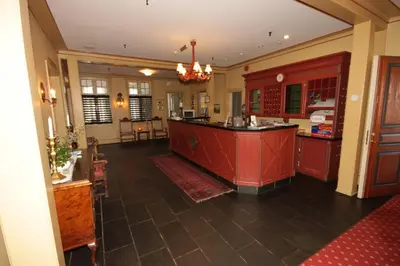 a kitchen with a red island in a room at Sauda Fjordhotell in Saudasjøen