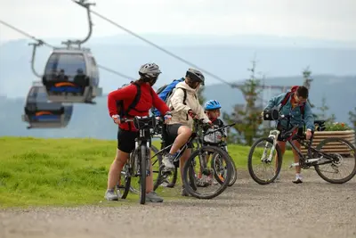 a group of people on bikes and a ski lift at Alpin Apartments Solsiden in Hafjell
