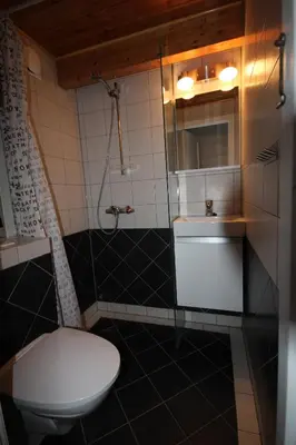 a bathroom with a toilet and a sink at Bratland Camping in Bergen