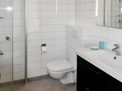 a white bathroom with a toilet and a sink at 8 person holiday home in Masfjordnes-By Traum in Masfjorden