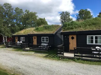a couple of buildings with a grass roof at Øen Turistsenter Cottages in Geilo