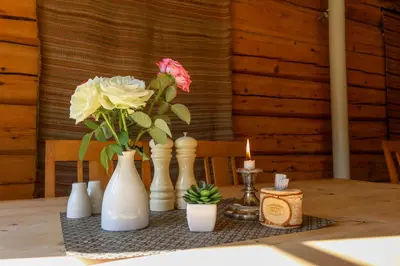a table with vases and candles and flowers on it at Jaunsen Gjestgjevarstad in Granvin