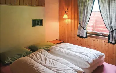 two beds in a room with a window at Stunning Home In Olden With Kitchen in Olden