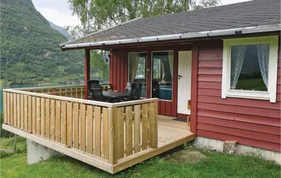 a small red house with a wooden deck at Stunning Home In Olden With Kitchen in Olden