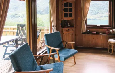 a porch with two chairs and a table and a window at Stunning Home In Olden With Kitchen in Olden